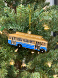 Hand-blown glass ornament of a gold and blue Laguna Beach Transit trolley bus